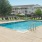 a swimming pool with chairs around it