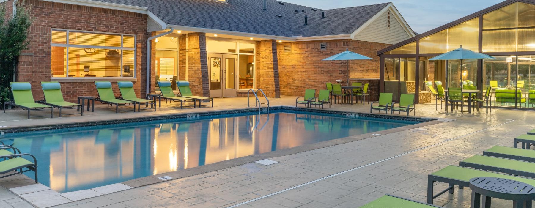 a swimming pool with a house in the background