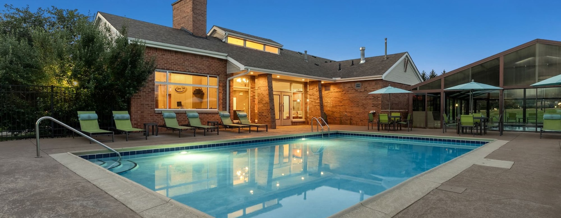 pool with reclining seats and nearness to apartments
