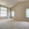 large room with several windows and carpet