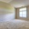 bedroom with a large widow and carpet