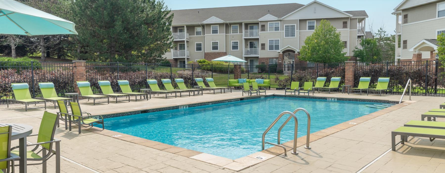 a swimming pool with chairs around it