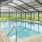 a swimming pool with chairs around it
